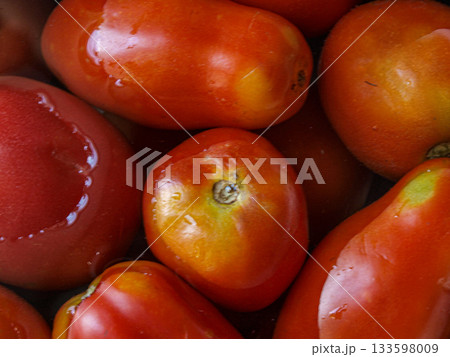 Tomatoes in water in a steel container Tomatoes in water in a steel container 133598009