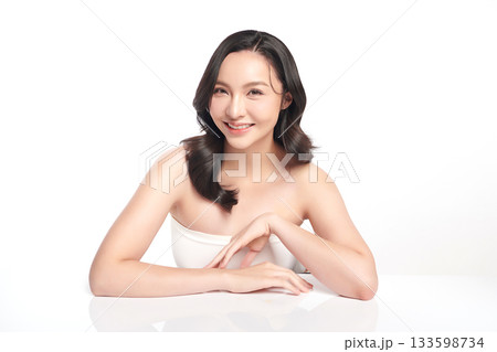 A beautiful young Asian woman with clean, fresh skin against a white background. Skincare, facial treatment, cosmetology, beauty, and spa. An elegant portrait of an Asian woman. A beautiful young Asian woman with clean, fresh skin against a white background. Skincare, facial treatment, cosmetology, beauty, and spa. An elegant portrait of an Asian woman. 133598734