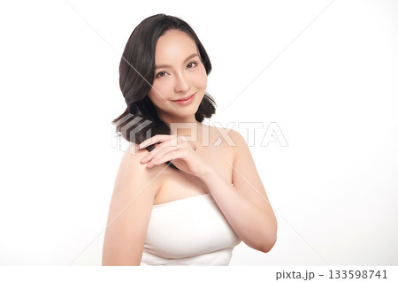 A beautiful young Asian woman with clean, fresh skin against a white background. Skincare, facial treatment, cosmetology, beauty, and spa. An elegant portrait of an Asian woman. A beautiful young Asian woman with clean, fresh skin against a white background. Skincare, facial treatment, cosmetology, beauty, and spa. An elegant portrait of an Asian woman. 133598741