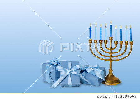 Menorah with blue candles beside wrapped gift boxes 133599065