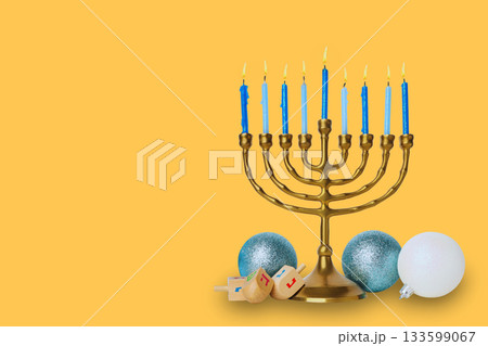 Blue candle menorah next to festive decor 133599067