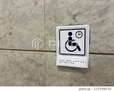 The best accessible sign with Braille text for reading using tactile dots. The concept of finger reading by tracing raised dots on text for people with disabilities 133599520