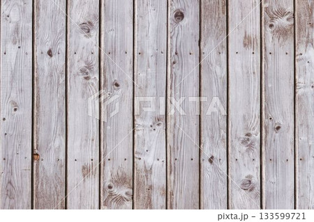 Vertical weathered planks are forming full-frame flat design showing grain and nail holes 133599721