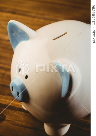 Cropped piggy bank on wooden table Cropped piggy bank on wooden table 133599796