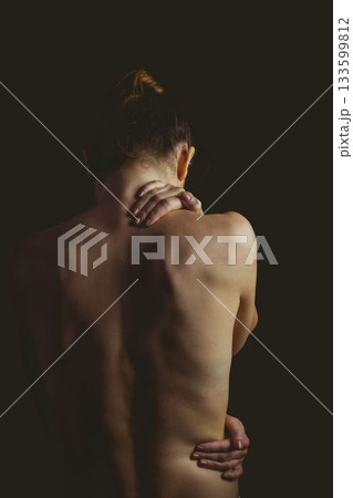 Single woman is placing hand on neck and highlighting spine in flat design with dark backdrop 133599812