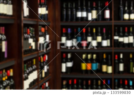 Wine bottles arranged in wooden shelf 133599830