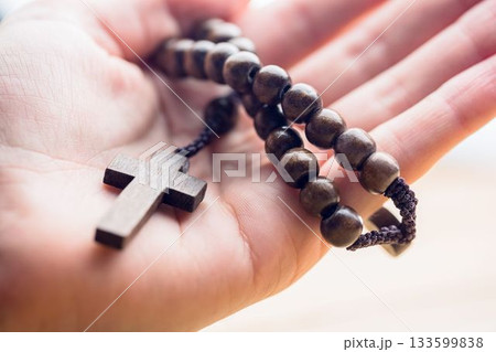 Hand holding rosary beads Hand holding rosary beads 133599838