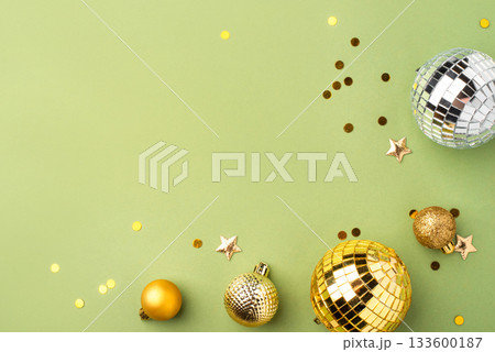 Christmas gold ornaments on a green background. 133600187