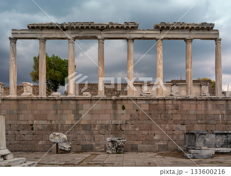 Majestic ancient colonnade at Pergamon Acropolis, Bergama, Turkey, under a dramatic cloudy sky. Majestic ancient colonnade at Pergamon Acropolis, Bergama, Turkey, under a dramatic cloudy sky. 133600216