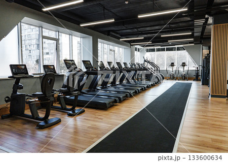 Modern gym interior with exercise equipment in a spacious fitness center Modern gym interior with exercise equipment in a spacious fitness center 133600634
