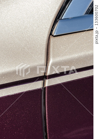 Detailed view of a classic car's door with sparkling paint in a vintage style 133600702