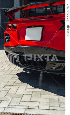 Luxury red sports car parked with attention to detail in an urban setting on a sunny day Luxury red sports car parked with attention to detail in an urban setting on a sunny day 133600707