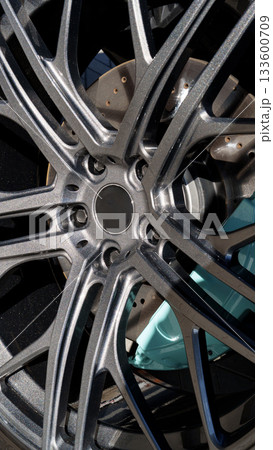 Detailed view of a modern alloy wheel showcasing intricate design and craftsmanship Detailed view of a modern alloy wheel showcasing intricate design and craftsmanship 133600709