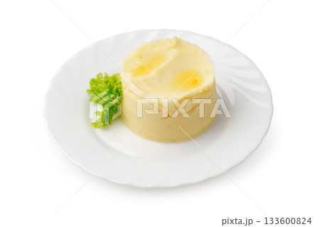 Mashed potato dish served on a white plate with fresh lettuce garnish 133600824
