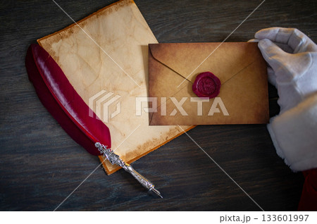 Close up of Santa Claus hands writing letter on Worden desk with copy space Close up of Santa Claus hands writing letter on Worden desk with copy space 133601997