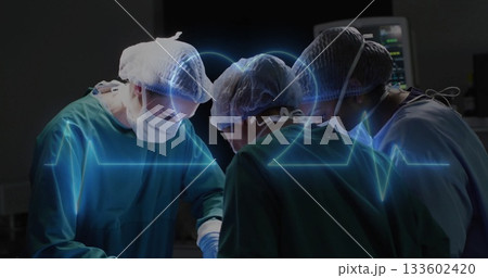Surgical team in surgical gowns performing surgery in OR, with holographic ECG waveform 133602420