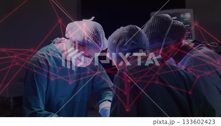 Surgical team using instruments in green scrubs in theatre, with monitor and red network overlay Surgical team using instruments in green scrubs in theatre, with monitor and red network overlay 133602423
