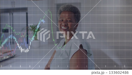 Woman tracking multicolored line chart overlay in home office with laptop and plant, copy space 133602486