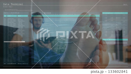 Touching holographic display by hand in office showing code logs with business casual colleagues 133602841