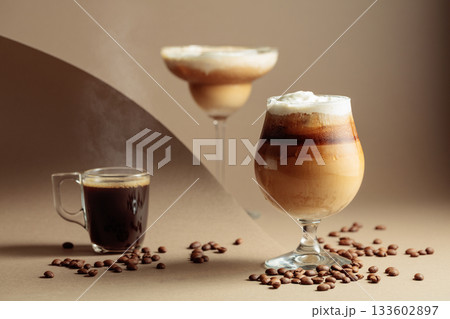 Black coffee and iced coffee cocktails on a beige background. Black coffee and iced coffee cocktails on a beige background. 133602897