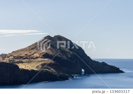 Close view of Sao Lourenco sea arch in cliffside with calm Atlantic stretching below 133603317
