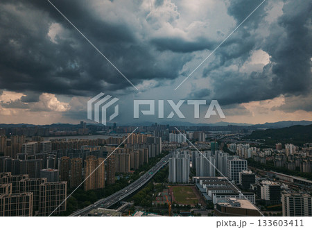 Aerial view of dark storm clouds looming over the cityscape of Hangzhou. Aerial view of dark storm clouds looming over the cityscape of Hangzhou. 133603411