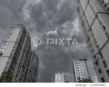 Tall residential buildings under a dramatic cloudy sky during daytime in China 133604663