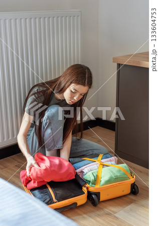 Woman packing suitcase for travel preparing for trip Woman packing suitcase for travel preparing for trip 133604753