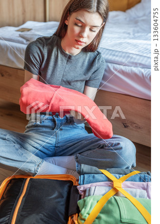 Woman packing clothes preparing for travel trip 133604755