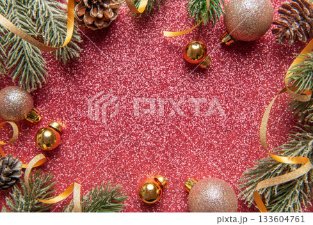 Festive christmas tree branches with baubles on glitter background Festive christmas tree branches with baubles on glitter background 133604761
