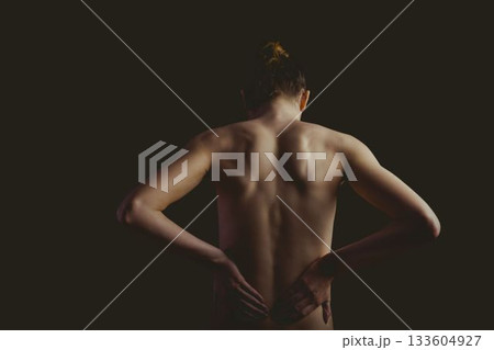 Female torso is being shown in vector art, highlighting back contours on black backdrop, copy space 133604927