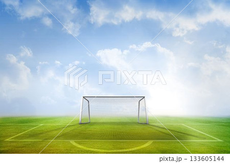 Football pitch and goal under blue sky 133605144