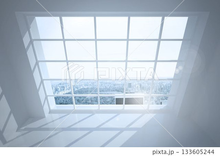 Room with large windows showing city 133605244