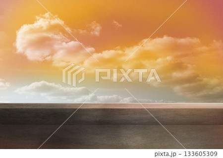 Flat design scene is showing grey paved surface meeting reflective horizon under warm tinted clouds 133605309