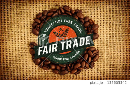 circular fair trade badge is resting in flat style on burlap surface, surrounded by coffee beans circular fair trade badge is resting in flat style on burlap surface, surrounded by coffee beans 133605342