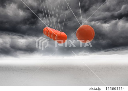 Newtons cradle above stormy desert 133605354