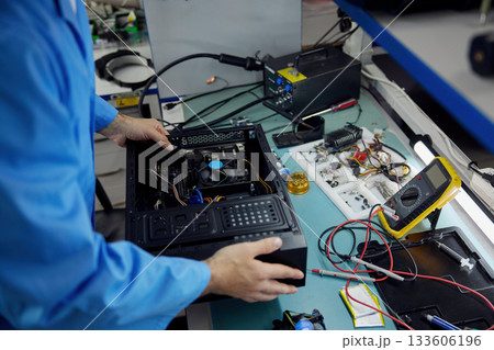 A man soldering technician is diligently working on his computer 133606196