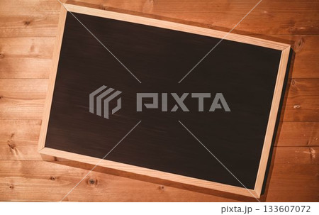 Small blackboard on wooden floor Small blackboard on wooden floor 133607072