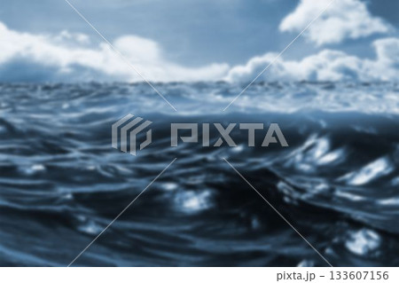 Ocean waves are rolling across dark blue flat design surface under heavy overcast clouds Ocean waves are rolling across dark blue flat design surface under heavy overcast clouds 133607156