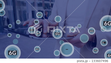 Tapping mature man wearing light blazer holding tablet in corporate plaza, with floating 6G icons Tapping mature man wearing light blazer holding tablet in corporate plaza, with floating 6G icons 133607496