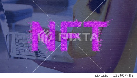 Holding laptop, female in yellow top hovering above keyboard in office, emitting glitch NFT overlay 133607498