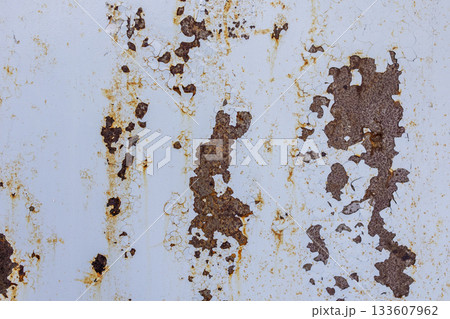 Abstract texture of cracked surface with rusty orange cracks on light background.Texture of metal sheet. Abstract texture of cracked surface with rusty orange cracks on light background.Texture of metal sheet. 133607962