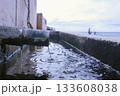 Discharge of dirty industrial wastewater into sea on waterfront. 133608038