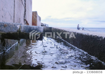 Discharge of dirty industrial wastewater into sea on waterfront. Discharge of dirty industrial wastewater into sea on waterfront. 133608038