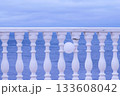 White fence with balloon on sea waterfront in a cloudy day. Beautiful seascape. 133608042