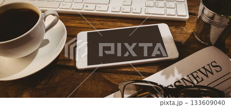 Showing flat design wooden desk with smartphone, coffee cup, keyboard, newspaper, eyeglasses, plant Showing flat design wooden desk with smartphone, coffee cup, keyboard, newspaper, eyeglasses, plant 133609040