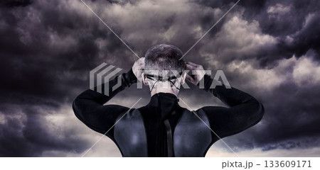 Rear view of male swimmer against cloudy sky Rear view of male swimmer against cloudy sky 133609171