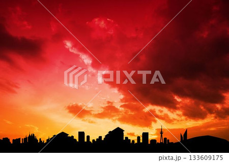 City skyline is glowing against fiery red sunset in flat design with skyscraper and tower outlines 133609175