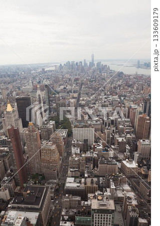 Depicting Manhattan skyline rising in flat design, showing grid streets with skyscrapers and taxis Depicting Manhattan skyline rising in flat design, showing grid streets with skyscrapers and taxis 133609179