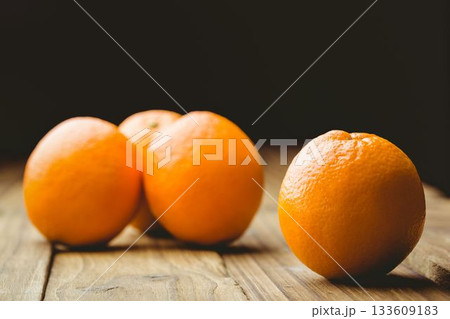 Close-up of oranges on wooden table 133609183